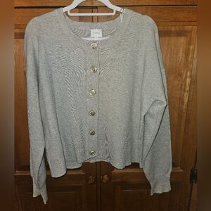 A great cardigan! Perfect neutral light tan with 6 beautiful gold buttons.